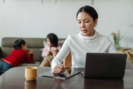 Woman sitting at table with notebook